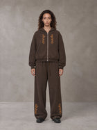 Model wearing the SM Shadow Pulse Hoodie and SM Shadow Pulse Sweatpants in Kabul Brown, front view.