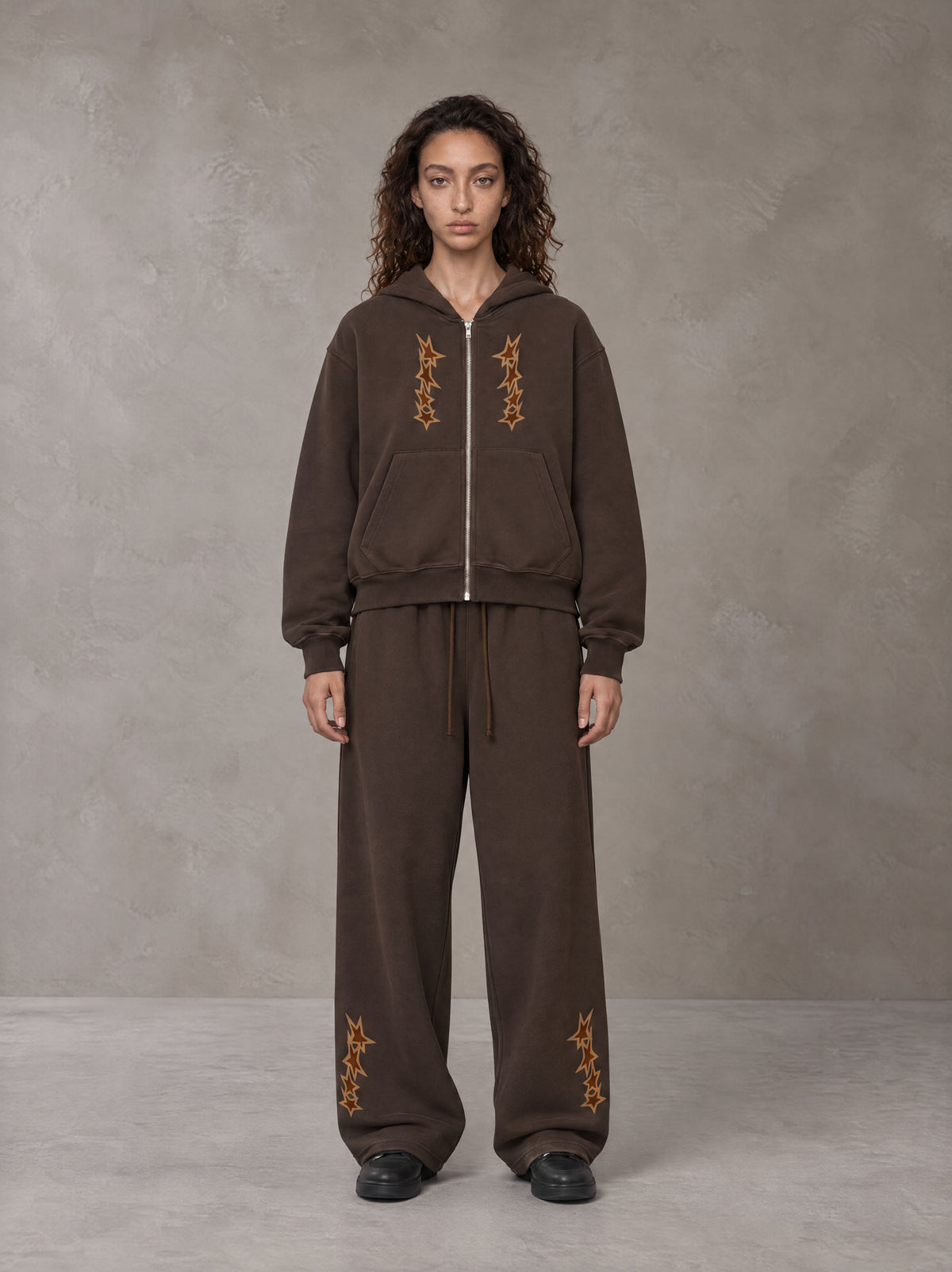 Model wearing the SM Shadow Pulse Hoodie and SM Shadow Pulse Sweatpants in Kabul Brown, front view.