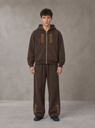 Model wearing the SM Shadow Pulse Hoodie and SM Shadow Pulse Sweatpants in Kabul Brown, front view.