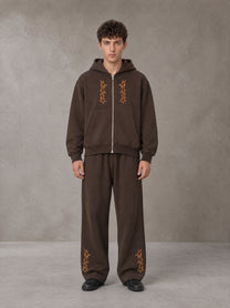 Model wearing the SM Shadow Pulse Hoodie and SM Shadow Pulse Sweatpants in Kabul Brown, front view.