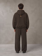 Model wearing the SM Shadow Pulse Hoodie and SM Shadow Pulse Sweatpants in Kabul Brown, rear view.