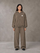 Model wearing the SM Arc Hoodie and SM Arc Sweatpants in Deep Coffee, front view.