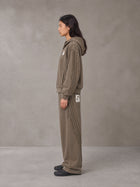 Model wearing the SM Arc Hoodie and SM Arc Sweatpants in Deep Coffee, side profile.
