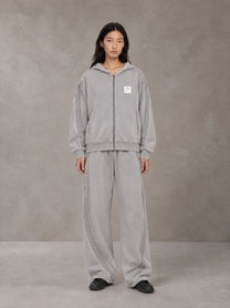 Model wearing the SM Arc Hoodie and SM Arc Sweatpants in Floral Grey, front view.