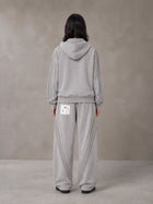 Model wearing the SM Arc Hoodie and SM Arc Sweatpants in Floral Grey, rear view.