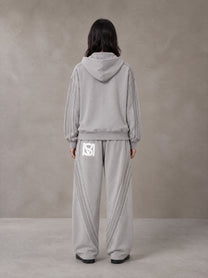 Model wearing the SM Arc Hoodie and SM Arc Sweatpants in Floral Grey, rear view.