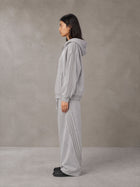 Model wearing the SM Arc Hoodie and SM Arc Sweatpants in Floral Grey, side profile.