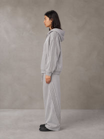 Model wearing the SM Arc Hoodie and SM Arc Sweatpants in Floral Grey, side profile.