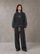 Model wearing the SM Grid Fleur Hoodie and SM Grid Fleur Sweatpants in Deep Charcoal, front view.