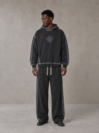 Model wearing the SM Grid Fleur Hoodie and SM Grid Fleur Sweatpants in Deep Charcoal, front view.
