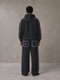 Model wearing the SM Grid Fleur Hoodie and SM Grid Fleur Sweatpants in Deep Charcoal, rear view.