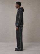 Model wearing the SM Grid Fleur Hoodie and SM Grid Fleur Sweatpants in Deep Charcoal, side profile.