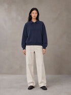 Model wearing SM Sig. Fleece Polo Sweatshirt in Oxford Navy, front view.