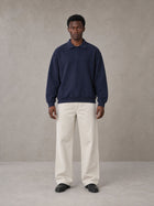 Model wearing SM Sig. Fleece Polo Sweatshirt in Oxford Navy, front view.