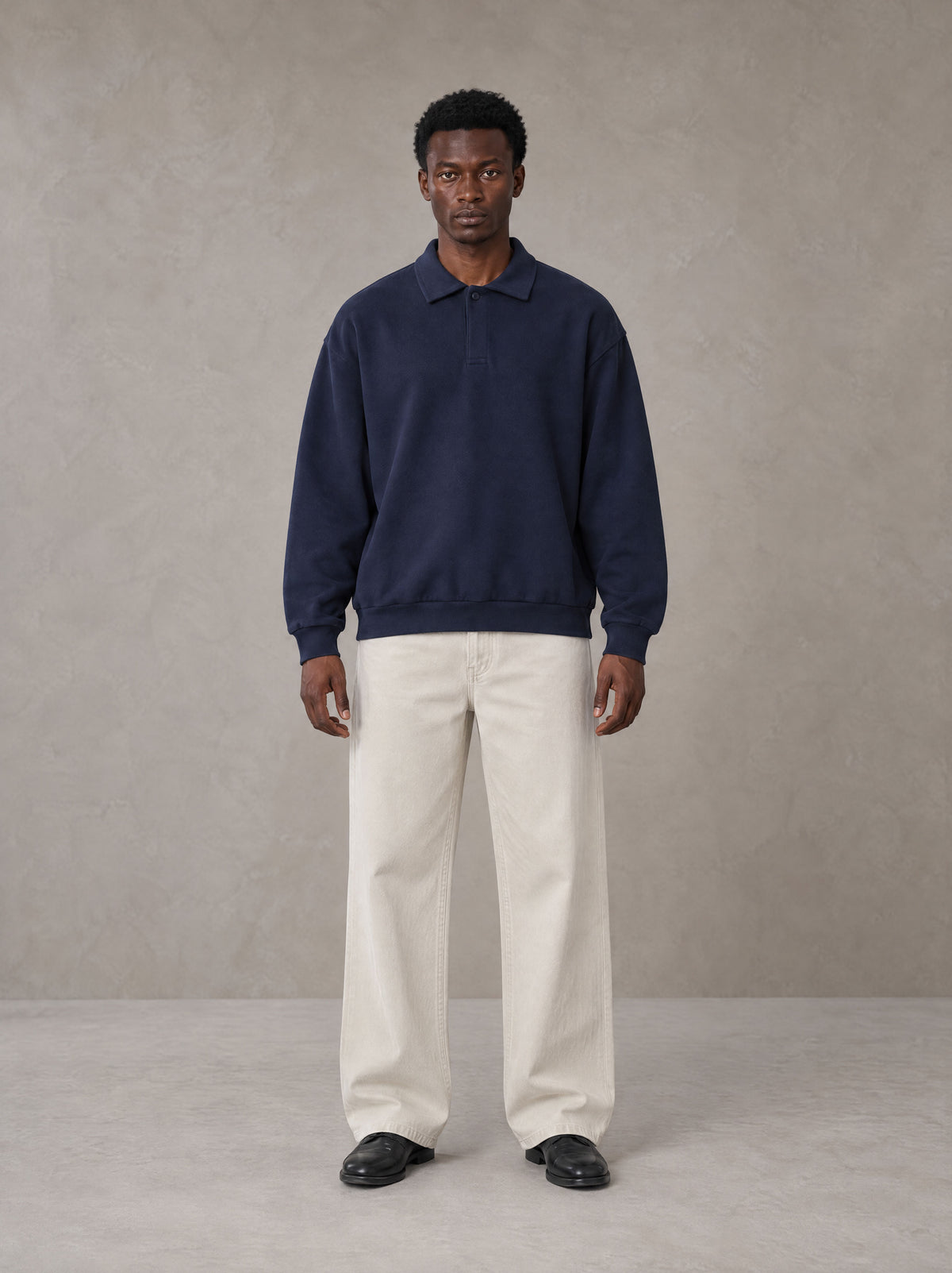Model wearing SM Sig. Fleece Polo Sweatshirt in Oxford Navy, front view.