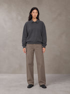 Model wearing SM Sig. Fleece Polo Sweatshirt in Deep Charcoal, front view.