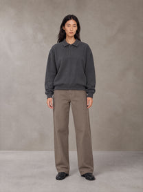 Model wearing SM Sig. Fleece Polo Sweatshirt in Deep Charcoal, front view.