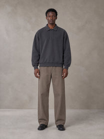 Model wearing SM Sig. Fleece Polo Sweatshirt in Deep Charcoal, front view.
