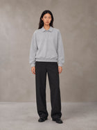 Model wearing SM Sig. Fleece Polo Sweatshirt in Floral Grey, front view.