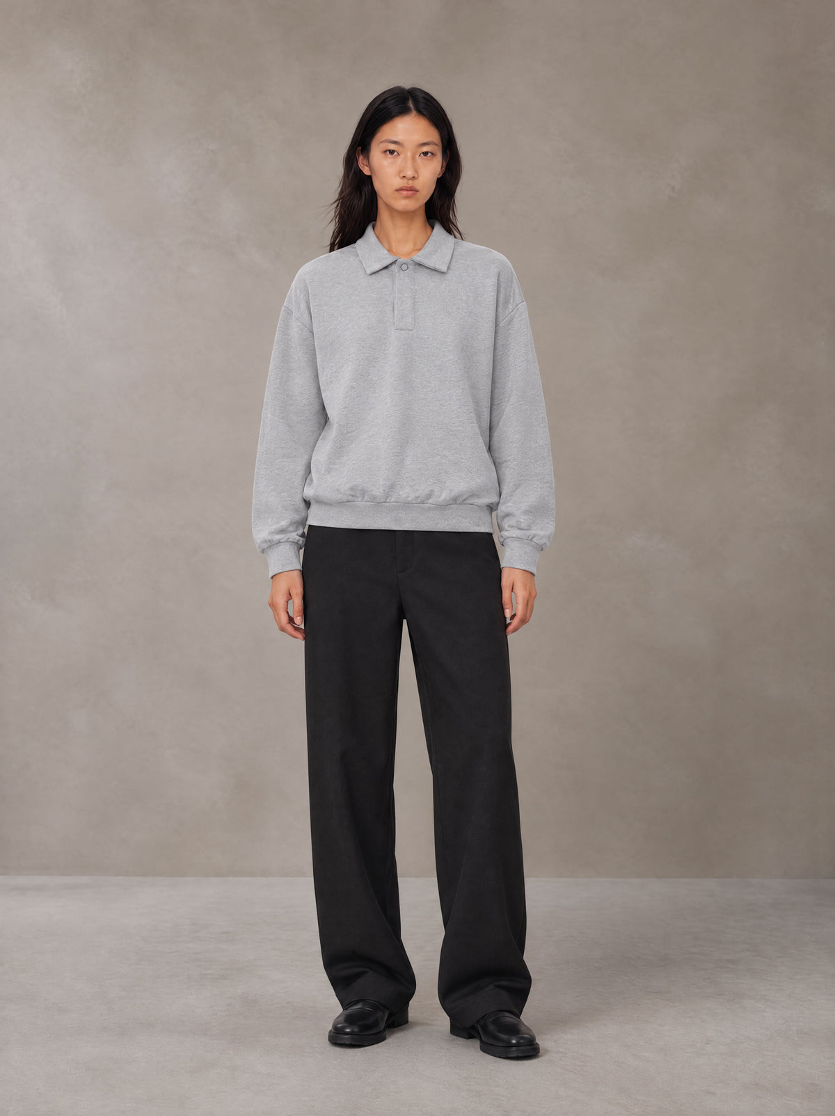 Model wearing SM Sig. Fleece Polo Sweatshirt in Floral Grey, front view.