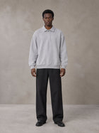 Model wearing SM Sig. Fleece Polo Sweatshirt in Floral Grey, front view.