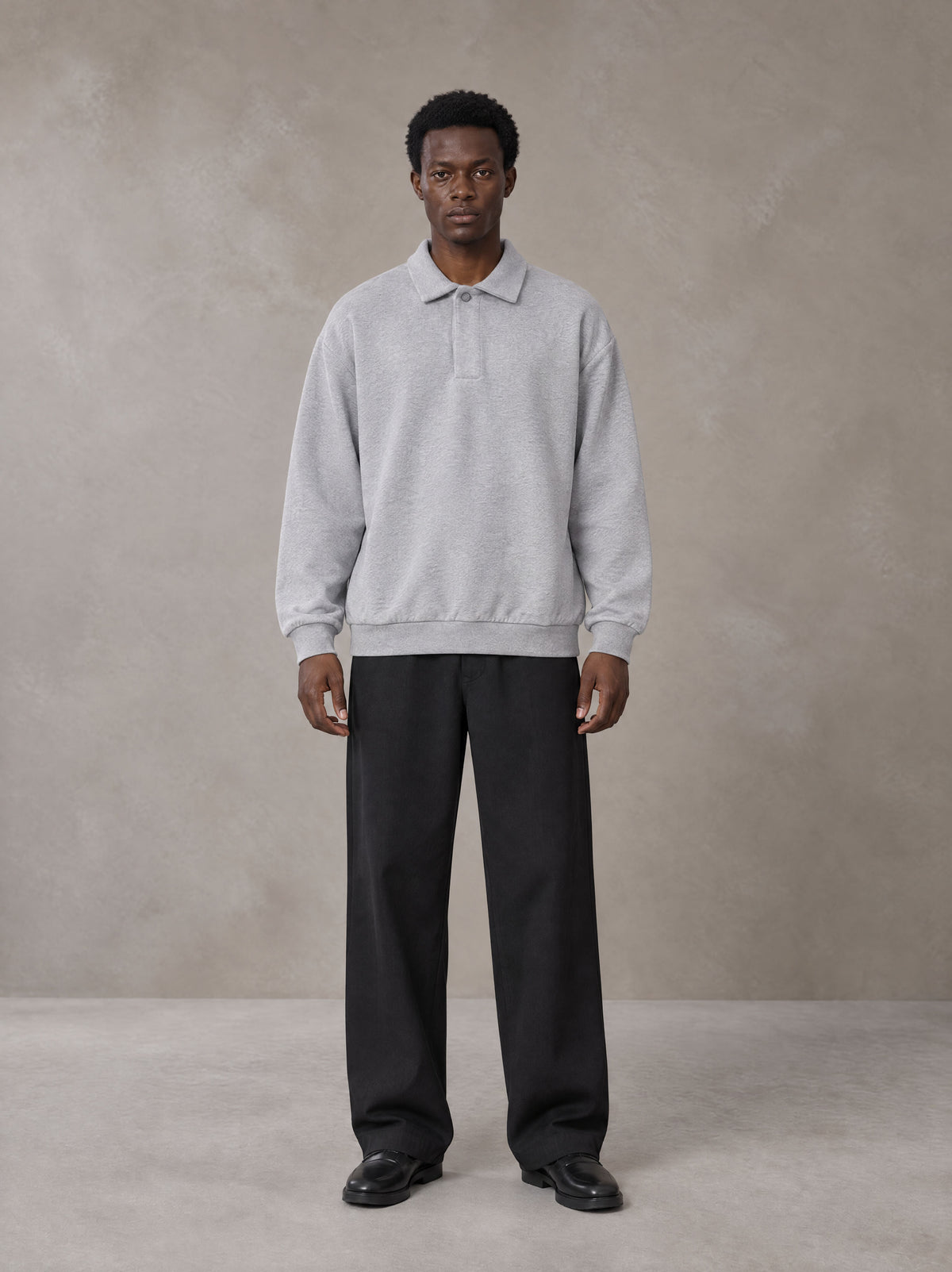 Model wearing SM Sig. Fleece Polo Sweatshirt in Floral Grey, front view.