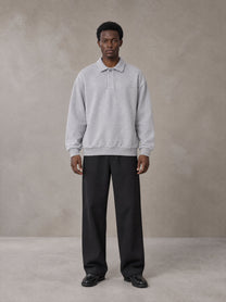 Model wearing SM Sig. Fleece Polo Sweatshirt in Floral Grey, front view.