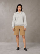 Model wearing SM Sig. Fleece Polo Sweatshirt in Oat Grey, front view.