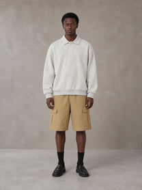 Model wearing SM Sig. Fleece Polo Sweatshirt in Oat Grey, front view.