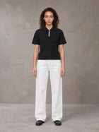 Model wearing SM Straight Leg Trousers in Lucent White, front view.