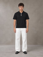 Model wearing SM Straight Leg Trousers in Lucent White, front view.