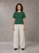 Model wearing SM Straight Leg Trousers in Oat Grey, front view.