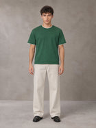 Model wearing SM Straight Leg Trousers in Oat Grey, front view.
