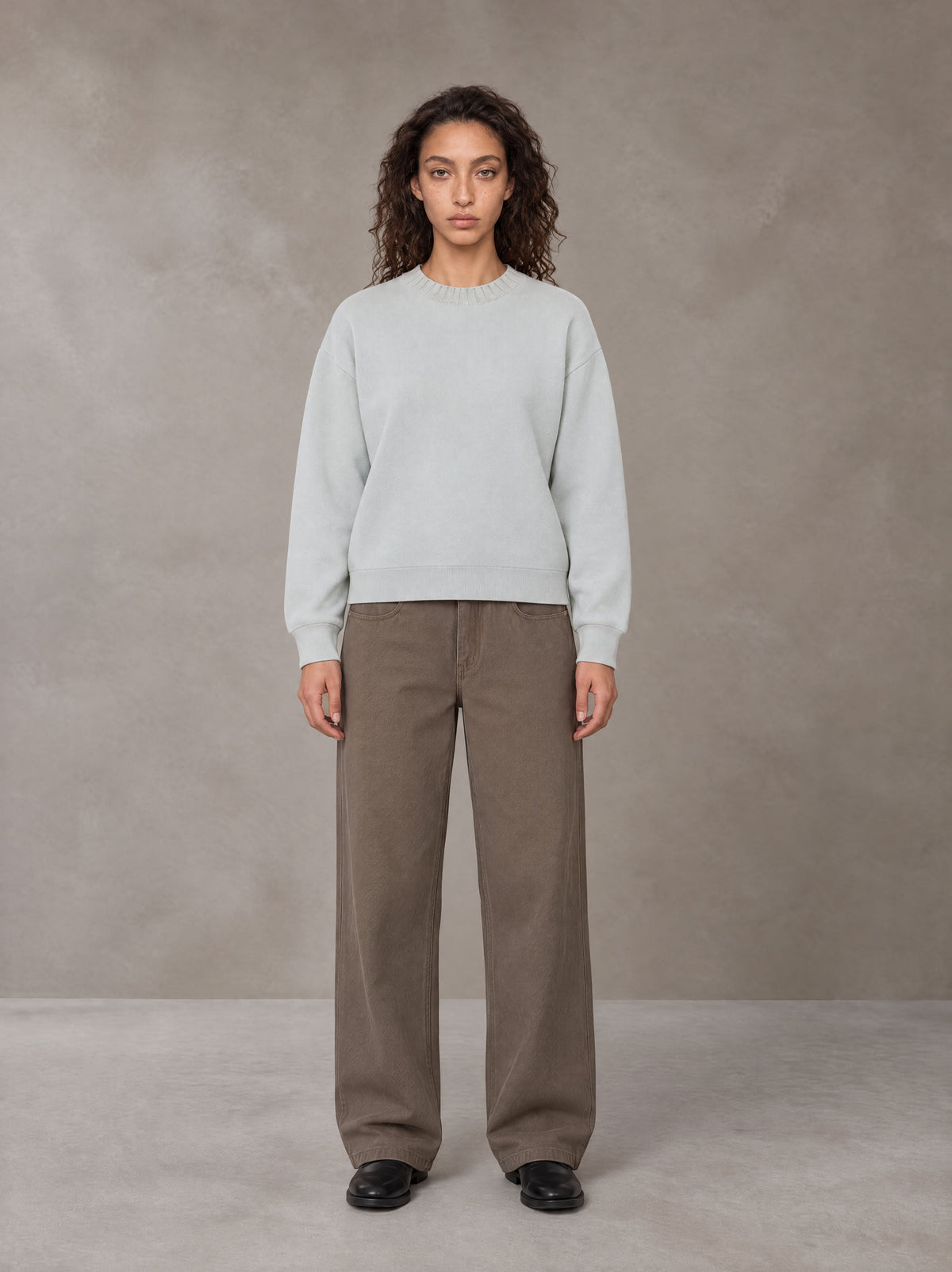 Model wearing SM Straight Leg Trousers in Kabul Brown, front view.