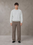Model wearing SM Straight Leg Trousers in Kabul Brown, front view.