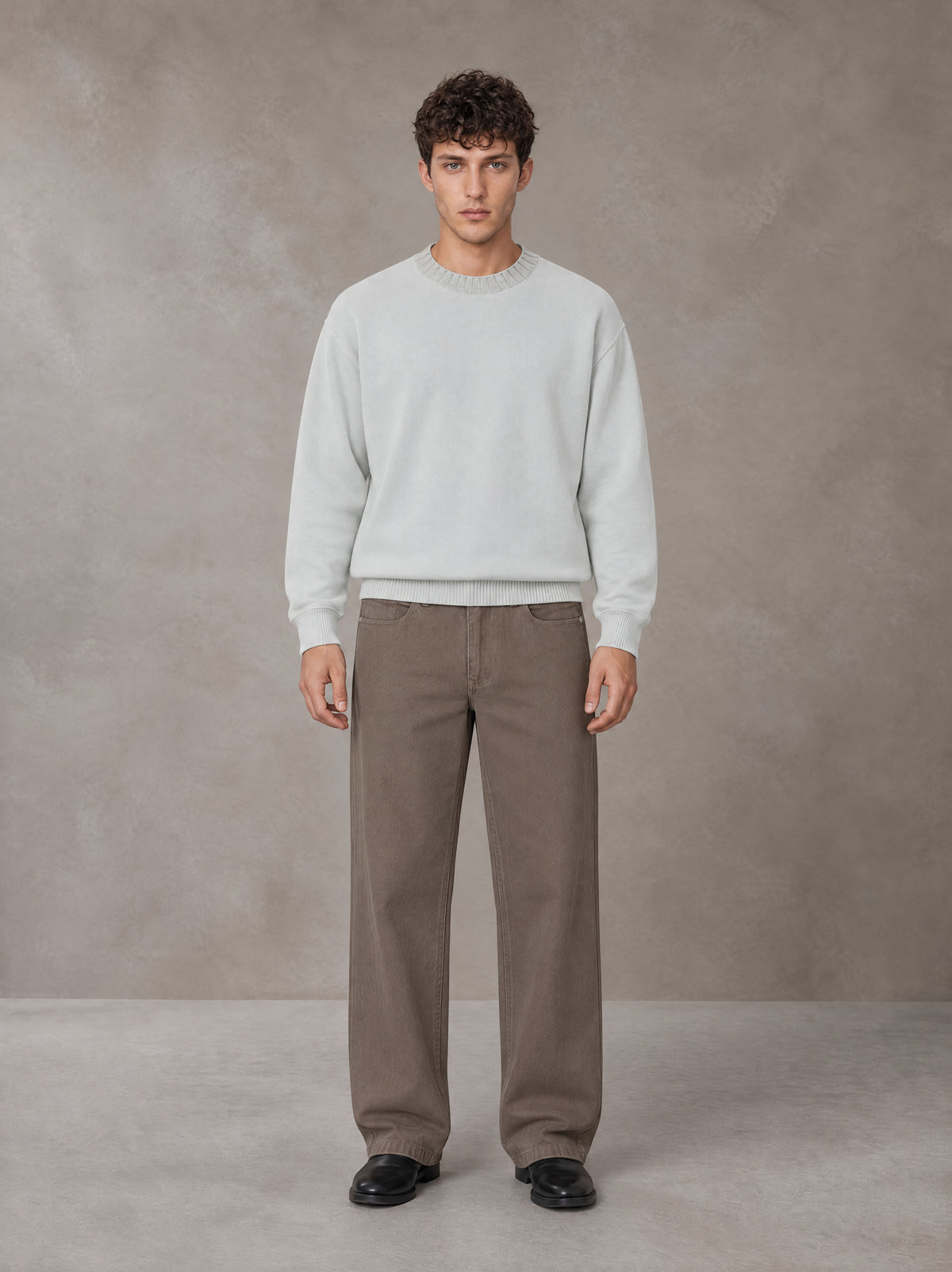 Model wearing SM Straight Leg Trousers in Kabul Brown, front view.
