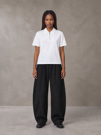 Model wearing SM Curved Trousers in Midnight Black, front view.