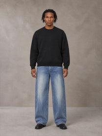 Model wearing SM Sig. Knitted Round Neck Sweatshirt in Midnight Black, front view.