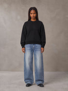 Model wearing SM Sig. Knitted Round Neck Sweatshirt in Midnight Black, front view.