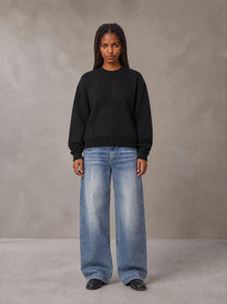 Model wearing SM Sig. Knitted Round Neck Sweatshirt in Midnight Black, front view.
