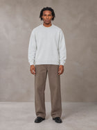 Model wearing SM Sig. Knitted Round Neck Sweatshirt in Solitude, front view.
