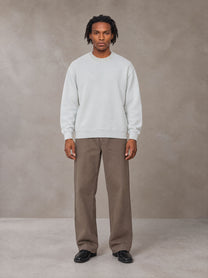 Model wearing SM Sig. Knitted Round Neck Sweatshirt in Solitude, front view.