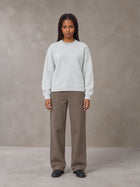 Model wearing SM Sig. Knitted Round Neck Sweatshirt in Solitude, front view.