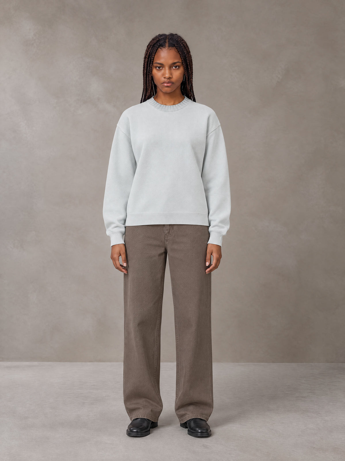 Model wearing SM Sig. Knitted Round Neck Sweatshirt in Solitude, front view.