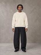 Model wearing SM Sig. Knitted Round Neck Sweatshirt in Neutral Heather, front view.