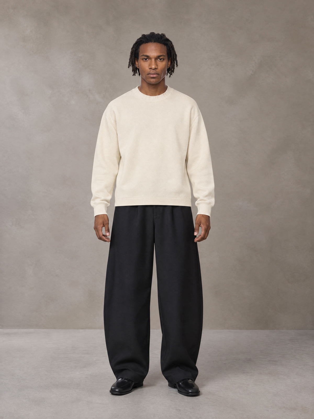 Model wearing SM Sig. Knitted Round Neck Sweatshirt in Neutral Heather, front view.