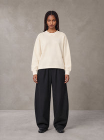 Model wearing SM Sig. Knitted Round Neck Sweatshirt in Neutral Heather, front view.