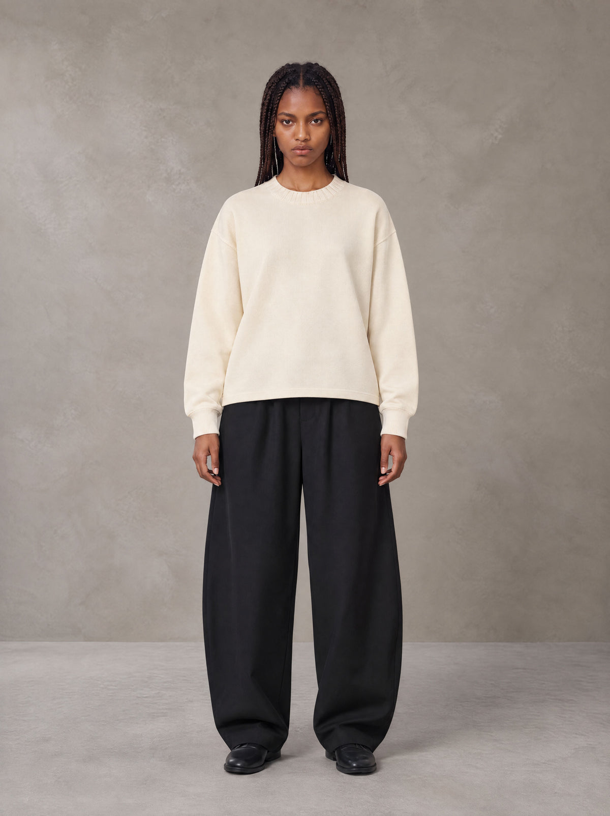 Model wearing SM Sig. Knitted Round Neck Sweatshirt in Neutral Heather, front view.