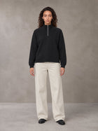 Model wearing SM Sig. Half-Zip Fleece Sweatshirt in Midnight Black, front view.