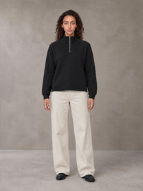 Model wearing SM Sig. Half-Zip Fleece Sweatshirt in Midnight Black, front view.